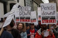 Members of the Writers Guild of America (WGA) East picket outside Peacock Newfront streaming service offices in New York City