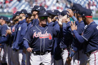 Atlanta Braves manager Brian Snitker high-fives members of the Braves before an opening day baseball game against the Washington Nationals at Nationals Park, Thursday, March 30, 2023, in Washington. (AP Photo/Alex Brandon)