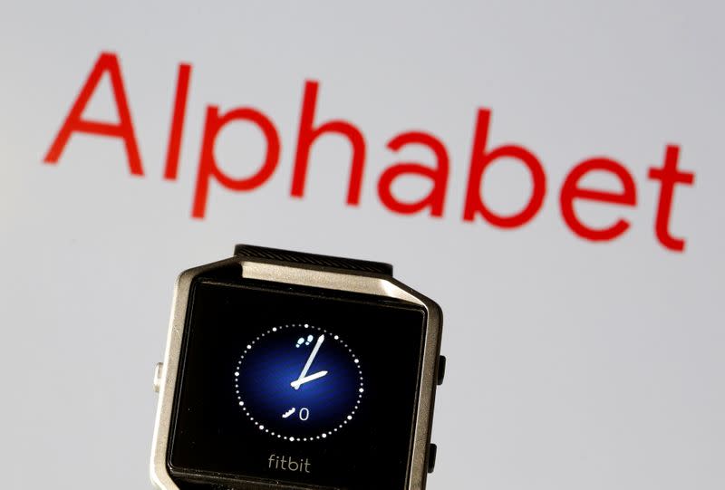 Fitbit Blaze watch is seen in front of a displayed Alphabet logo in this illustration