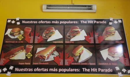 A banner shows burgers and sandwiches at the private cafeteria "Mcdunald" in Villa Clara province, Cuba, November 14, 2015. REUTERS/Enrique de la Osa