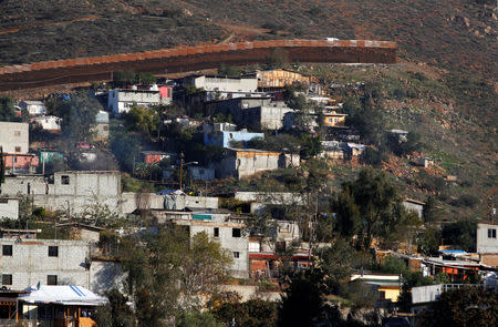 Houses are seen next to the border fence between Mexico and the U.S., as seen from Tijuana, Mexico January 7, 2019. REUTERS/Jorge Duenes