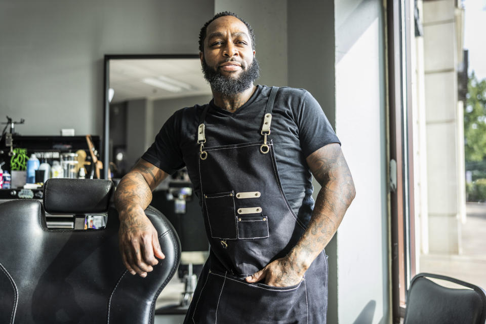 Male salon owner standing in his salon