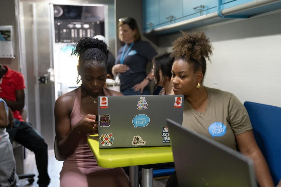 Nerisa Mukwe, an incoming senior at Northland High School, works with Pashia Spalding, a college advising manager with college access nonprofit I Know I Can, to sign up for the Common App inside I Know I Can's College & Career Coach on July 24.