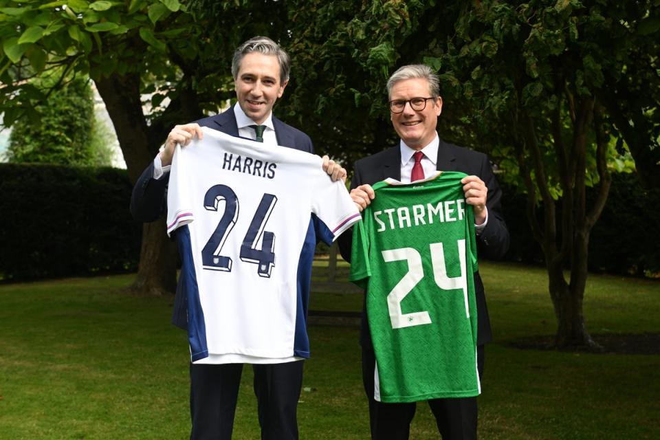 The two leaders exchanged personalised jerseys before a football match (Challes McQuillan/PA) (PA Wire)