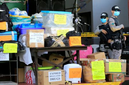 Members of Philippine Drug Enforcement Agency (PDEA) stand guard besides confiscated illegal drugs such as methamphetamine hydrochloride, referred as Shabu, cocaine, marijuana, ephedrine, ketamine, pseudoephedrine and expired medicines, during the destruction of illegal drugs at a waste management facility in Trece Martires town, Cavite, south of Manila July 14, 2016. REUTERS/Romeo Ranoco/File Photo