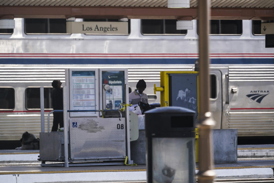 People wait on an Amtrak train platform at Union Station in Los Angeles as stoppages are announced on Wednesday, Sept. 14, 2022. Some Amtrak routes will be disrupted due to freight railroad labor negotiations. (AP Photo/Ashley Landis)