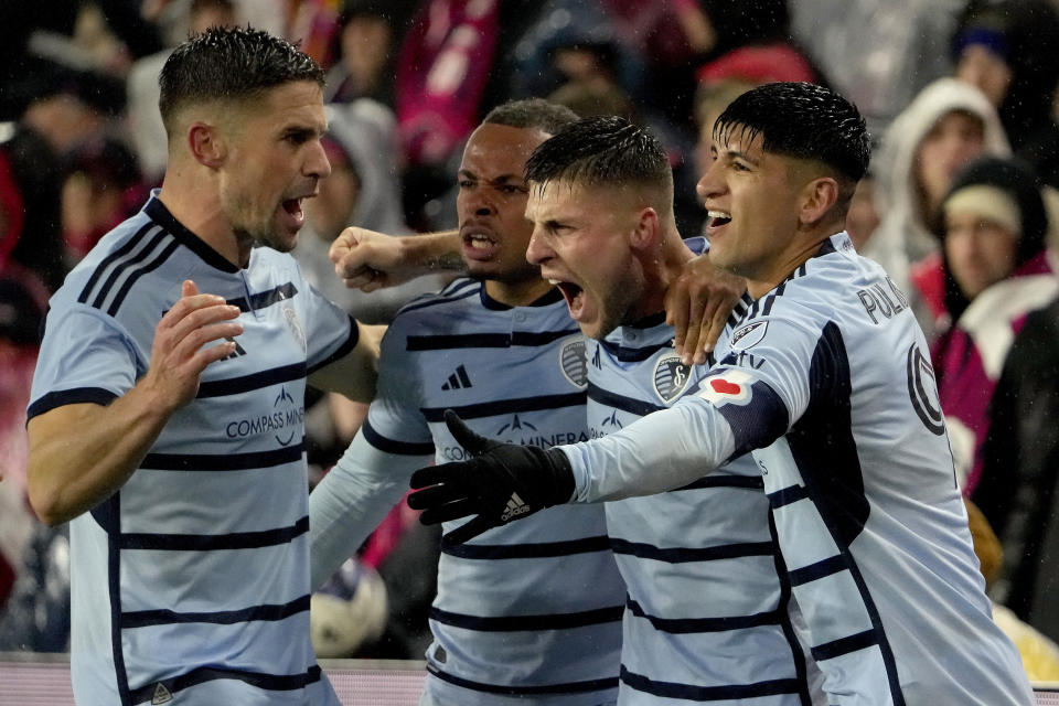 Sporting Kansas City players from left, Rémi Walter, Logan Ndenbe, Dany Rosero and Alán Pulido celebrate after Walter scored a goal during the first half of an MLS playoff soccer match against St. Louis City Sunday, Oct. 29, 2023, in St. Louis. (AP Photo/Jeff Roberson)