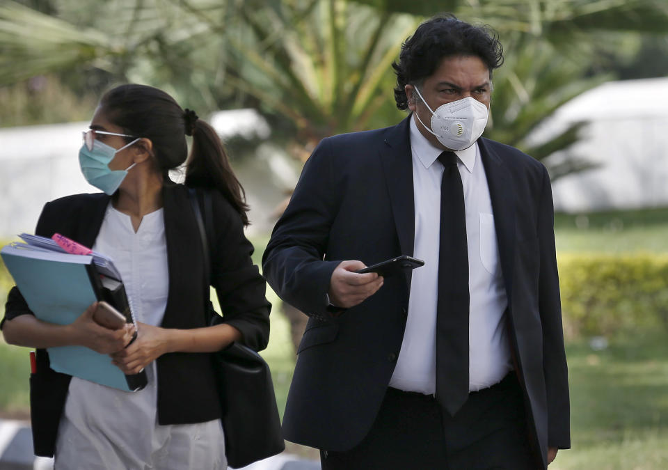 Faisal Siddiqi, right, a lawyer for the family of Daniel Pearl, an American reporter who was kidnapped and killed in Pakistan, arrives at the Supreme Court for an appeal hearing in the Pearl case, in Islamabad, Pakistan, Monday, Sept. 28, 2020. Pakistan's Supreme Court is to hear an appeal Monday by the family of Pearl that challenges the acquittal of a British-born Pakistani in the gruesome 2002 beheading of the Wall Street Journal reporter. (AP Photo/Anjum Naveed)