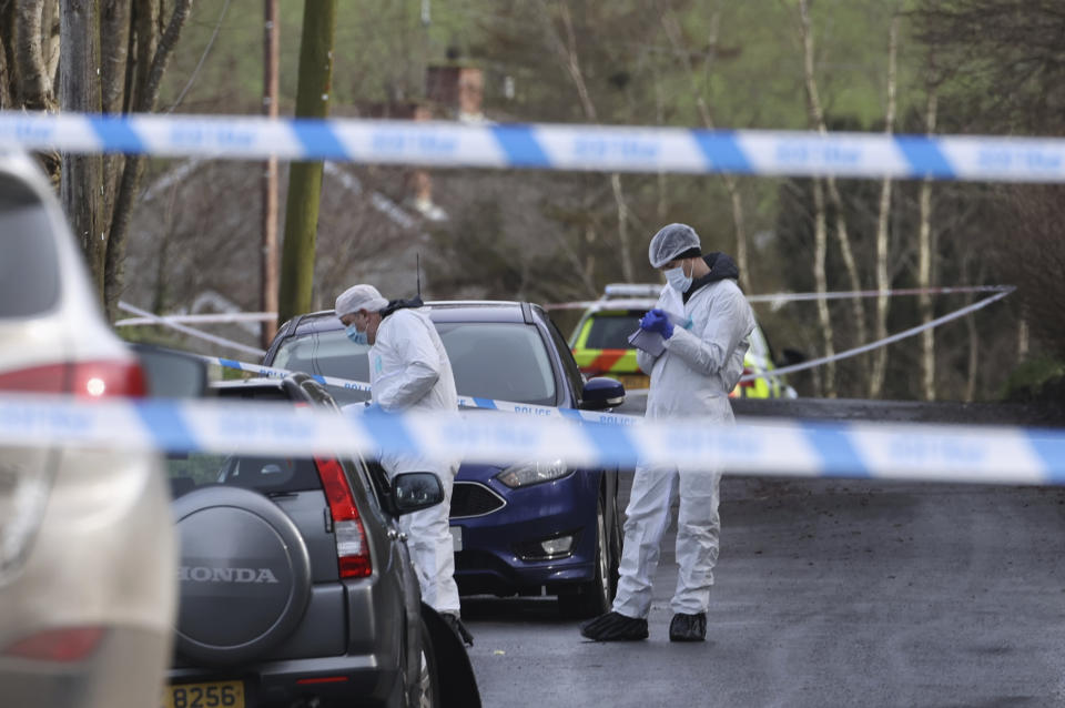 Forensic investigators from Police Service of Northern Ireland (PSNI) work at the sports complex in the Killyclogher Road area of Omagh, Co Tyrone, Northern Ireland Thursday, Feb. 23, 2023 where off-duty PSNI Detective Chief Inspector John Caldwell was shot. A senior Northern Ireland police officer is in critical but stable condition in a hospital after being shot by two masked men while he coached children’s soccer. Police said Thursday that a dissident Irish Republican Army splinter group is suspected of shooting the detective at a sports complex in the town of Omagh on Wednesday night. (Liam McBurney/PA via AP)