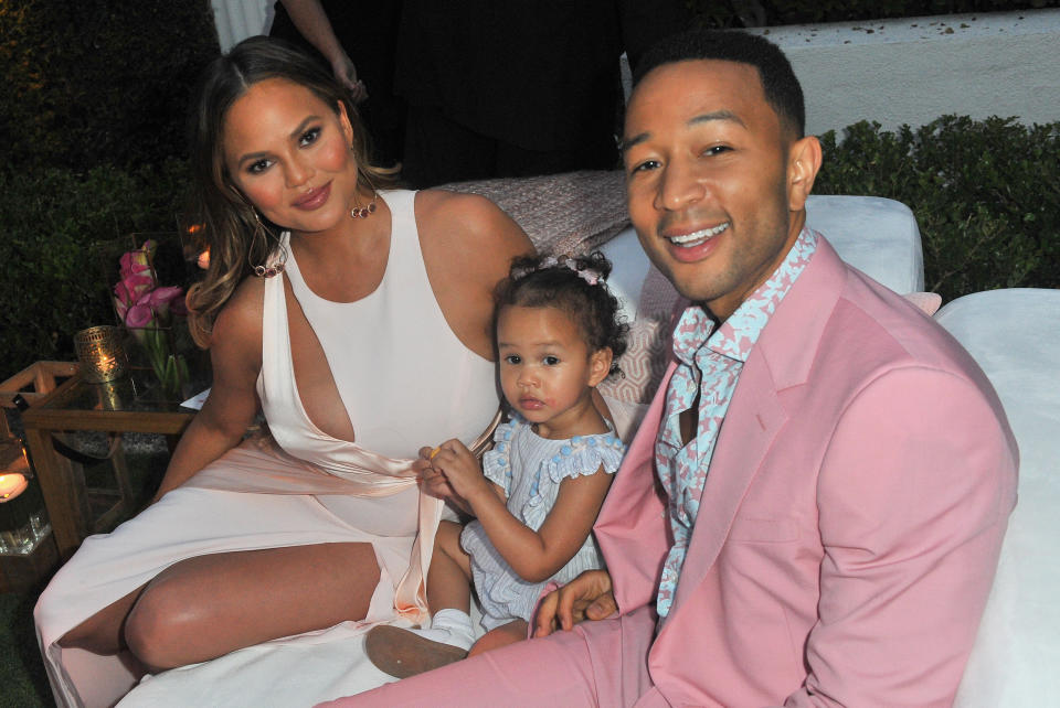 Chrissy Teigen — pictured with John Legend and their daughter, Luna — is having a stressful flight. (Photo: Jerod Harris/Getty Images for Airbnb)