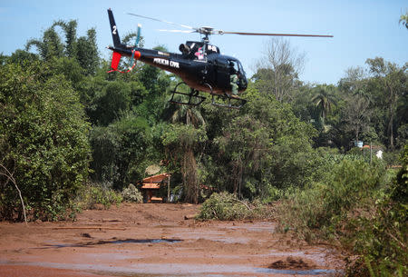 A rescue helicopter is seen over Paraopeba river after a tailings dam owned by Brazilian mining company Vale SA collapsed, in Brumadinho, Brazil January 31, 2019. REUTERS/Adriano Machado