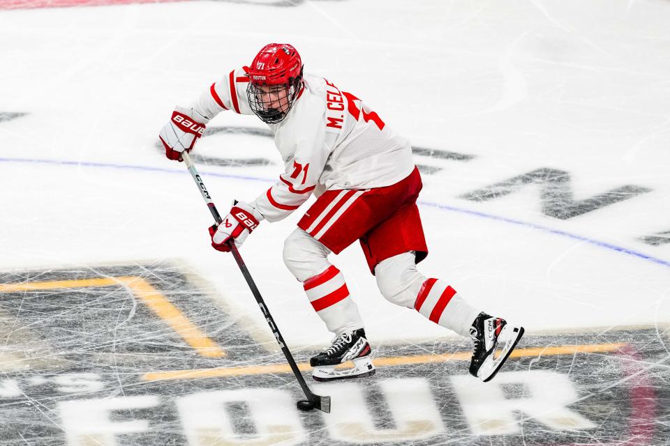 Boston U forward Macklin Celebrini (71) carries the puck in the semifinals of the 2024 Frozen Four college ice hockey tournament during the second period against Denver at Xcel Energy Center.