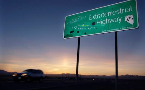 A vehicle moves along the Extraterrestrial Highway near Rachel, Nevada, the closest town to Area 51 - Credit: AP