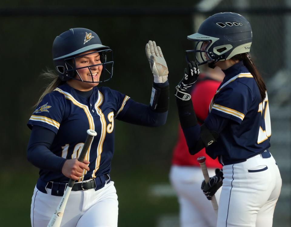 Tallmadge's Emma Garbinsky celebrates on her way back to the dugout after scoring on a hit by Sydney Becks during the fifth inning of a baseball game against Revere.