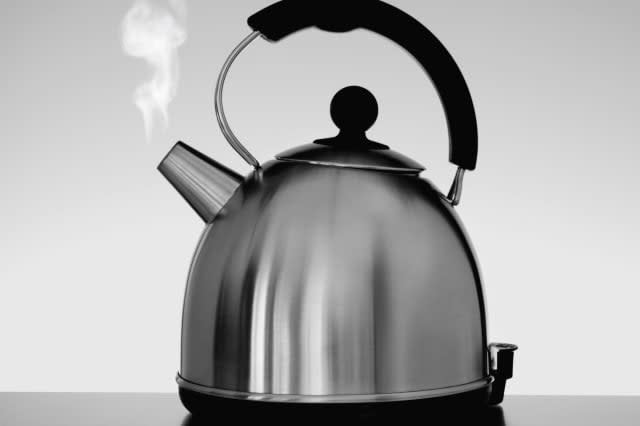 Tea kettle with steam indoors