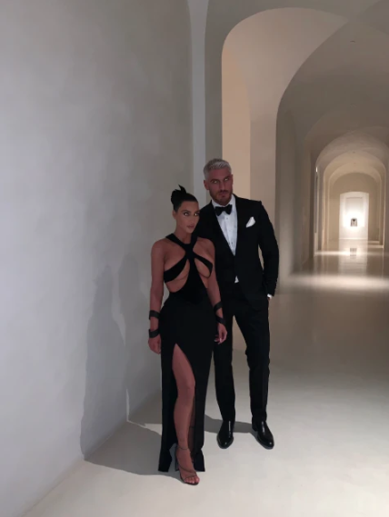 Kim standing in one of her hallways which is completely empty and gives off major sterile vibes