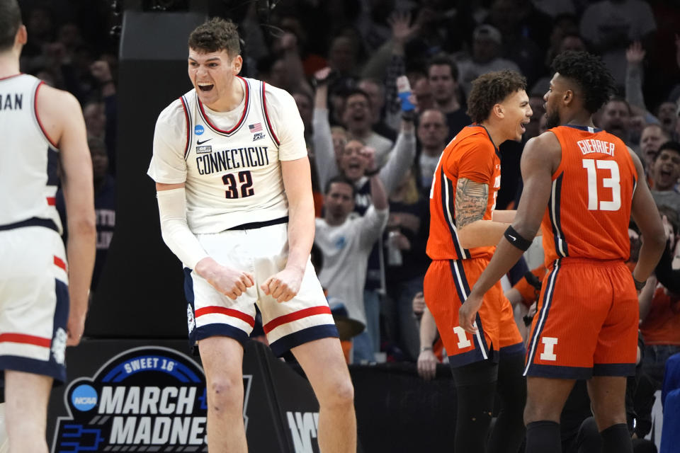 UConn center Donovan Clingan (32) celebrates after his dunk against Illinois during the first half of the Elite 8 college basketball game in the men's NCAA Tournament, Saturday, March 30, 2024, in Boston. (AP Photo/Michael Dwyer)