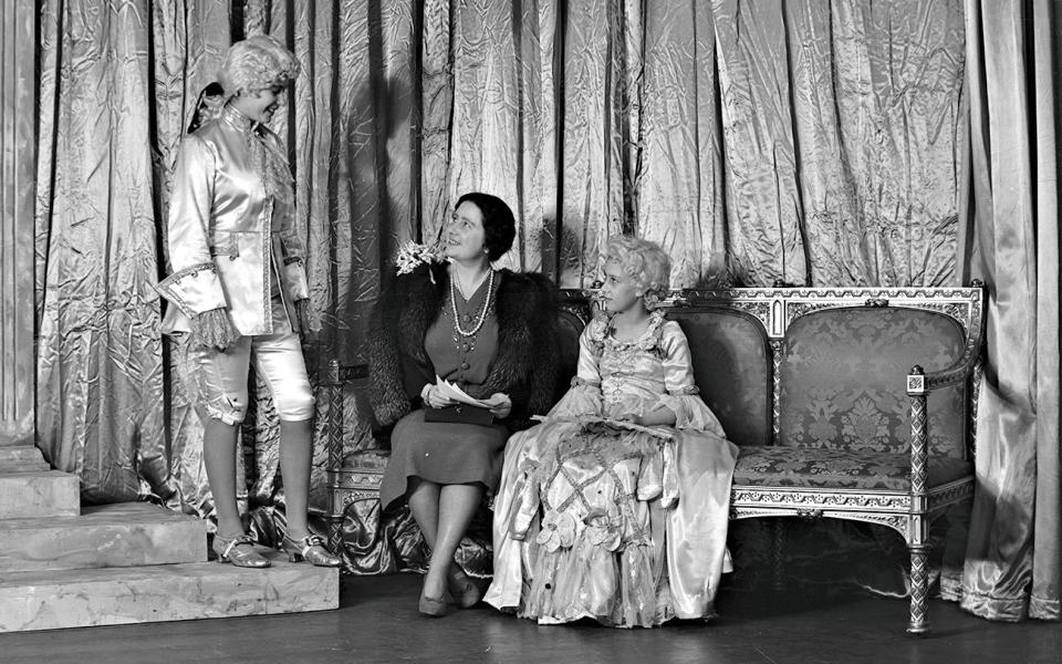  Princess Elizabeth, Queen Elizabeth and Princess Margaret during a royal pantomime at Windsor Castle in 1941. - Getty Images 