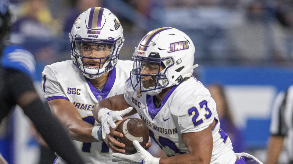 James Madison quarterback Billy Atkins (11) hands off the ball to running back Sammy Malignaggi (23) in the second half of an NCAA college football game against Georgia State, Saturday, Nov. 4 2023, in Atlanta. (AP Photo/Hakim Wright Sr.)