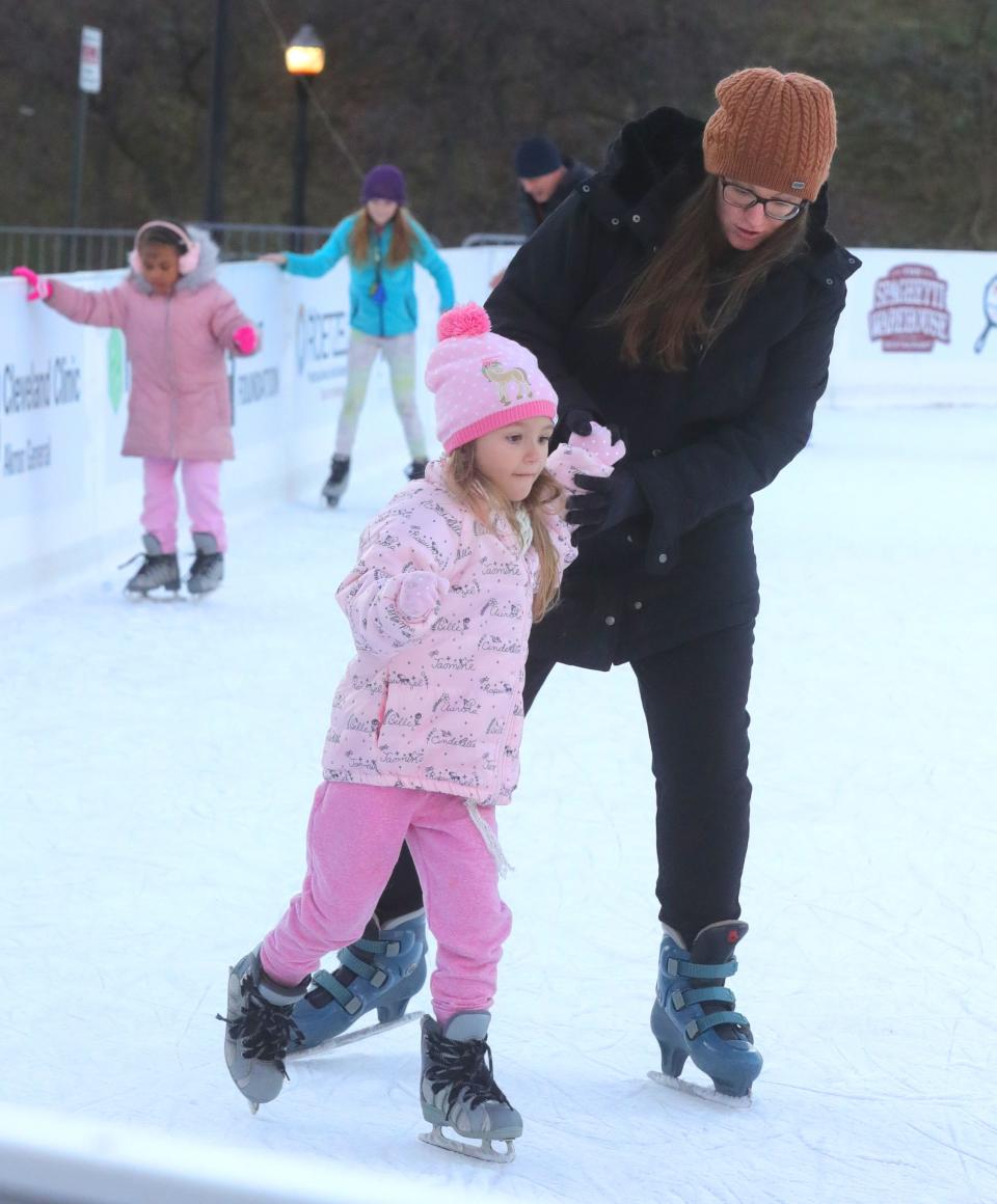 Kelly Treen and daughter Madeline, 5, skate at Lock 3 park last month in Akron.