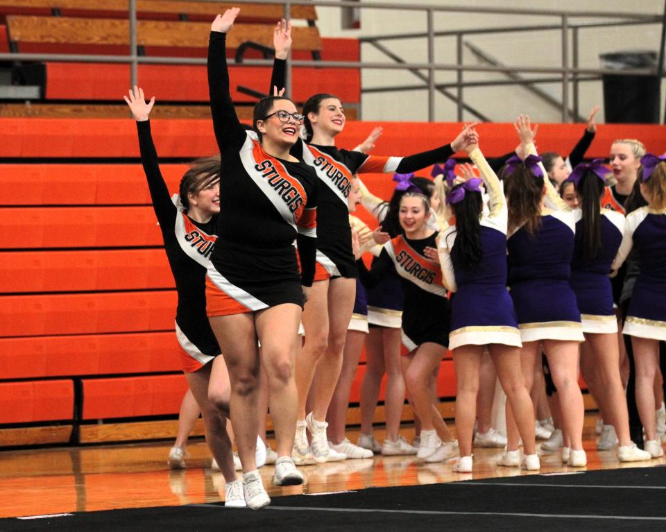 Solana Gonzalez leads the Sturgis competitive cheer team onto the floor in competition earlier this year.
