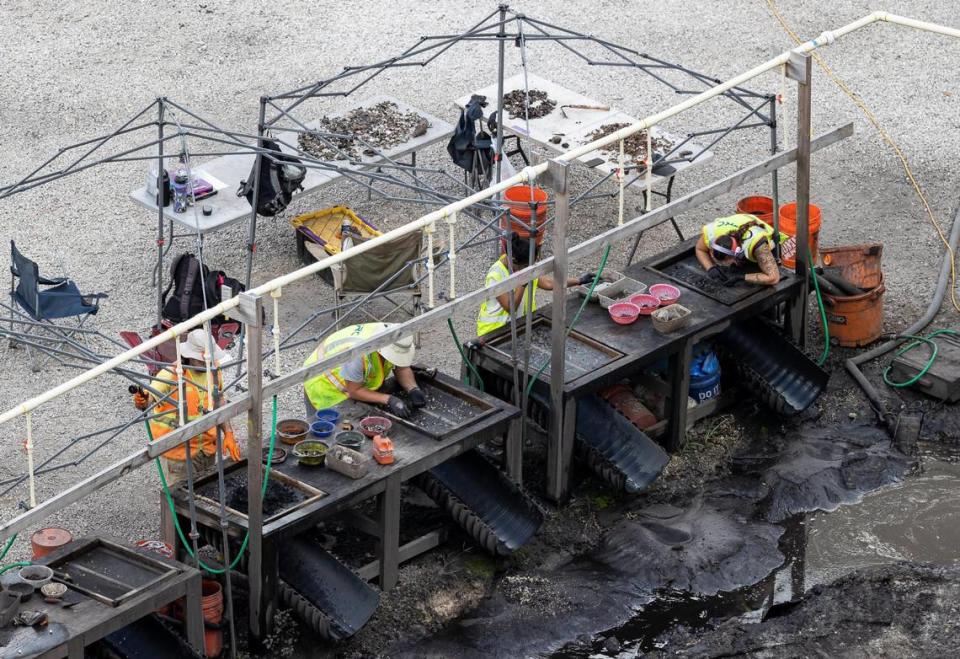 People are seen working an archaeological dig site located near Brickell on the River on Monday, Jan. 30, 2023, in Miami. Artifacts going back 7,000 years have been found at the site, along with postholes, gravesites, human remains and other evidence of substantial settlement by the Tequesta Native American tribe.