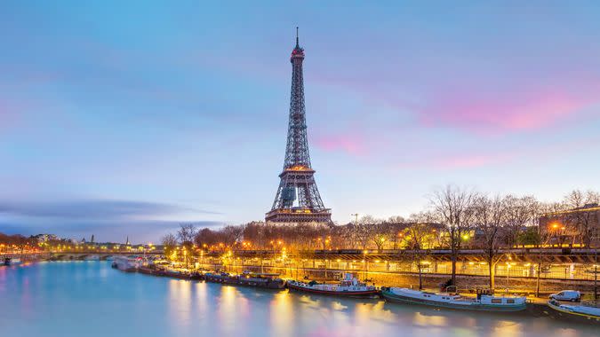 The Eiffel Tower and river Seine at twilight in Paris, France.