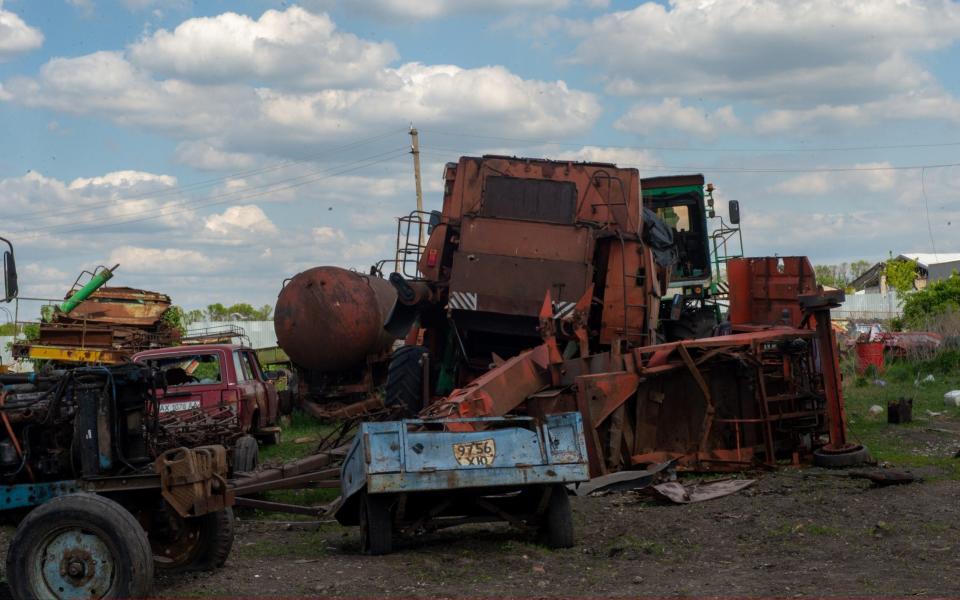 Damaged vehicles and damaged agricultural equipment are seen at a farm after Russian attacks in the village of Vilkhivka, Kharkiv region -  Anadolu/ Anadolu