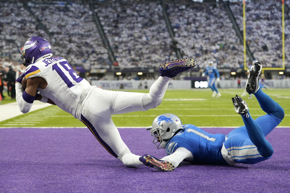 Minnesota Vikings wide receiver Justin Jefferson (18) catches a 26-yard touchdown pass over Detroit Lions cornerback Cameron Sutton (1) during the first half of an NFL football game, Sunday, Dec. 24, 2023, in Minneapolis. (AP Photo/Abbie Parr)