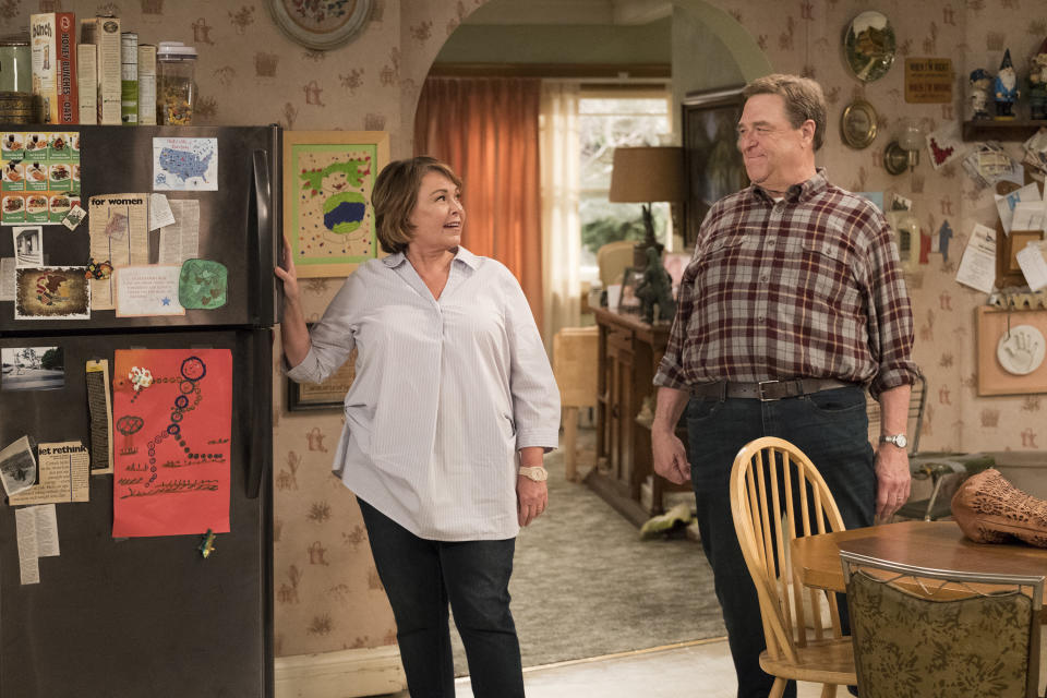 This image released by ABS shows Roseanne Barr, left, and John Goodman in a scene from the comedy series "Roseanne." ABC's "Roseanne" revival is in the running for Emmy nominations Thursday, but will TV academy voters overlook its star's racist tweet that brought the sitcom to an abrupt end? (Adam Rose/ABC via AP)