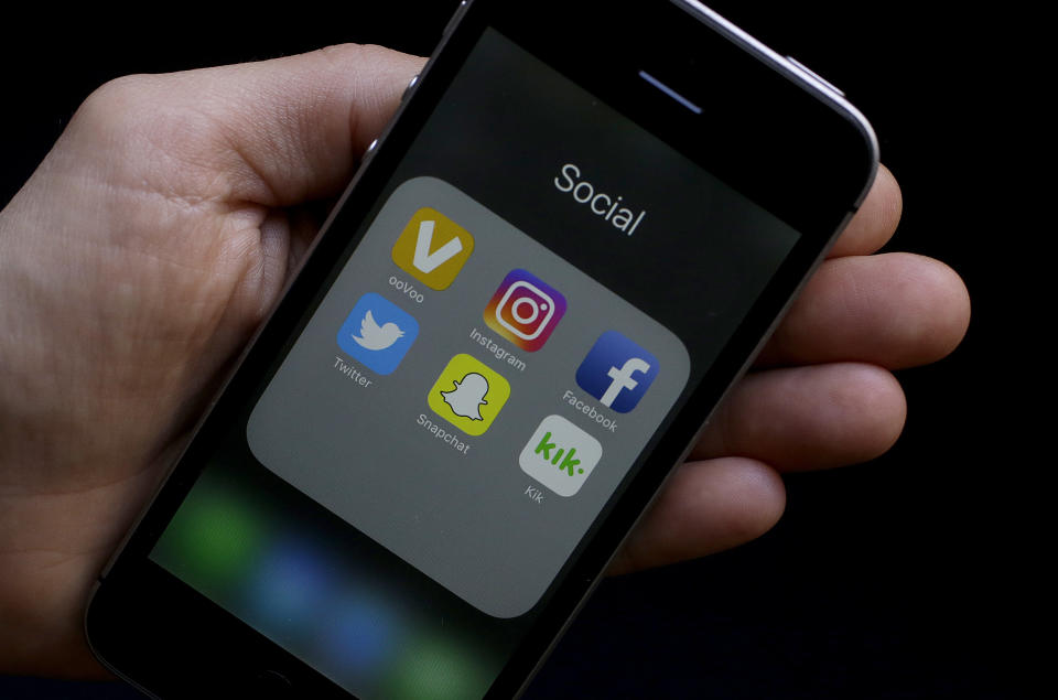 FILE - This June 16, 2017, file photo shows social media app icons on a smartphone held by an Associated Press reporter in San Francisco. The Ivy League university announced Monday, June 17, 2019, that it would revoke an admission offer to a survivor of the Parkland high school massacre because of racist social media posts. The decision serves as a reminder to aspiring college students and all young people that their online comments, even those considered private, can resurface and be used against them. (AP Photo/Jeff Chiu, File)