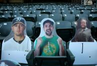 <p>Cutouts representing fans are seen during the first inning of the Oakland Athletics versus San Francisco Giants exhibition Bay Bridge game against at the Coliseum in Oakland on Monday July 20.</p>