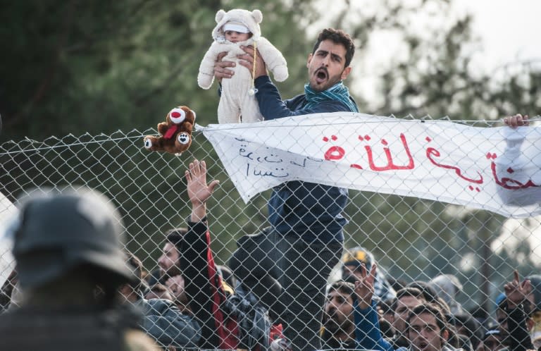 Migrants protest behind a fence against restrictions limiting passage at the Greek-Macedonian border, near Gevgelija, on December 1, 2015 Since last week, Macedonia has restricted passage to northern Europe to only Syrians, Iraqis and Afghans who are considered war refugees. All other nationalities are deemed economic migrants and told to turn back. Macedonia on November 29 finished building a fence on its frontier with Greece becoming the latest country in Europe to build a border barrier aimed at checking the flow of migrants