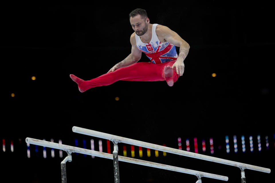 Great Britain's James Hall competes on the parallel bars during the Men's team final at the Artistic Gymnastics World Championships in Antwerp, Belgium, Tuesday, Oct. 3, 2023. (AP Photo/Geert Vanden Wijngaert)