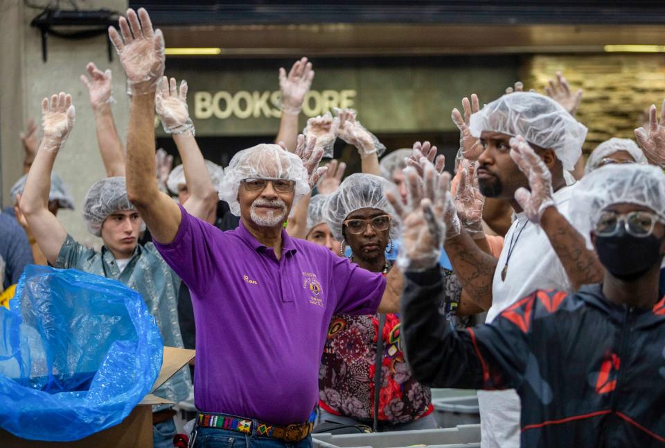Ron Coleman, 80, a past district governor for the Lions Club International, raises his hands alongside other Lions Club International members inside the Wayne County Community College in Detroit on Saturday, June 10, 2023. 