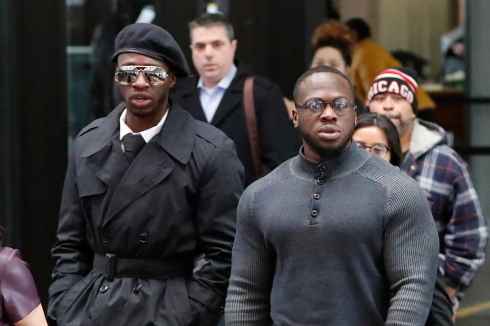 Brothers Olabinjo Osundairo, left, and Abimbola Osundairo arrive at the Leighton Criminal Courthouse in Chicago (AP)