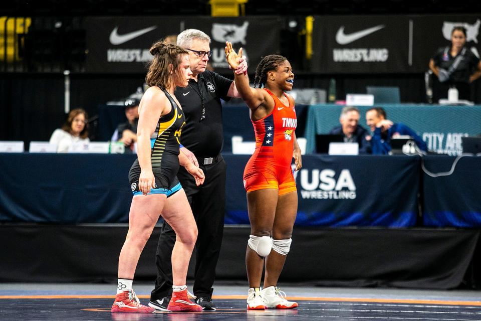 Dymond Guilford, right, has her hand raised after scoring a technical fall against Victoria Francis at 76 kg during the third session of the USA Wrestling World Team Trials Challenge Tournament on May 22 at Xtream Arena in Coralville.