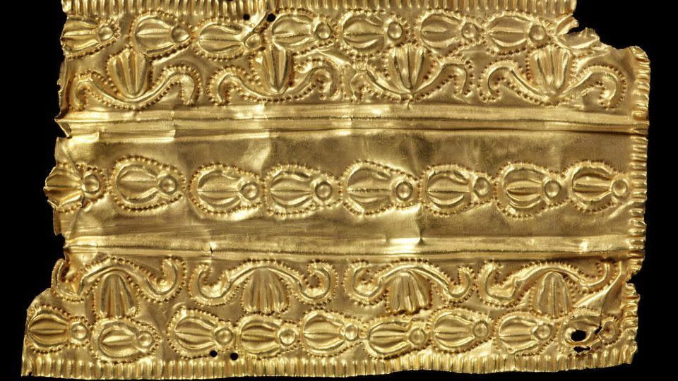 A gold ornament with three bands of decoration. - Victoria and Albert Museum