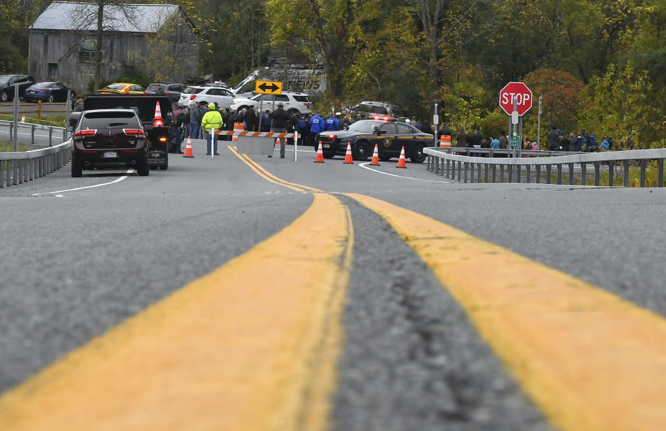 Family members and friends gather with first responders at the Reflections Memorial for a memorial unveiling ceremony, on the one year anniversary of the Schoharie limousine crash, at the site of the crash, that killed 20 people next to the Apple Barrel Restaurant Saturday, Oct. 5, 2019, in Schoharie, N.Y. (AP Photo/Hans Pennink)