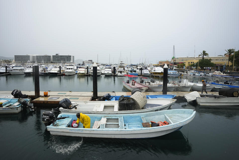 A fisherman removes water from his fishing boat in preparation for the arrival of the hurricane Norma, in Cabo San Lucas, Mexico, Friday, Oct. 20, 2023. Hurricane Norma is heading for the resorts of Los Cabos at the southern tip of Mexico's Baja California Peninsula, while Tammy grew into a hurricane in the Atlantic. (AP Photo/Fernando Llano)