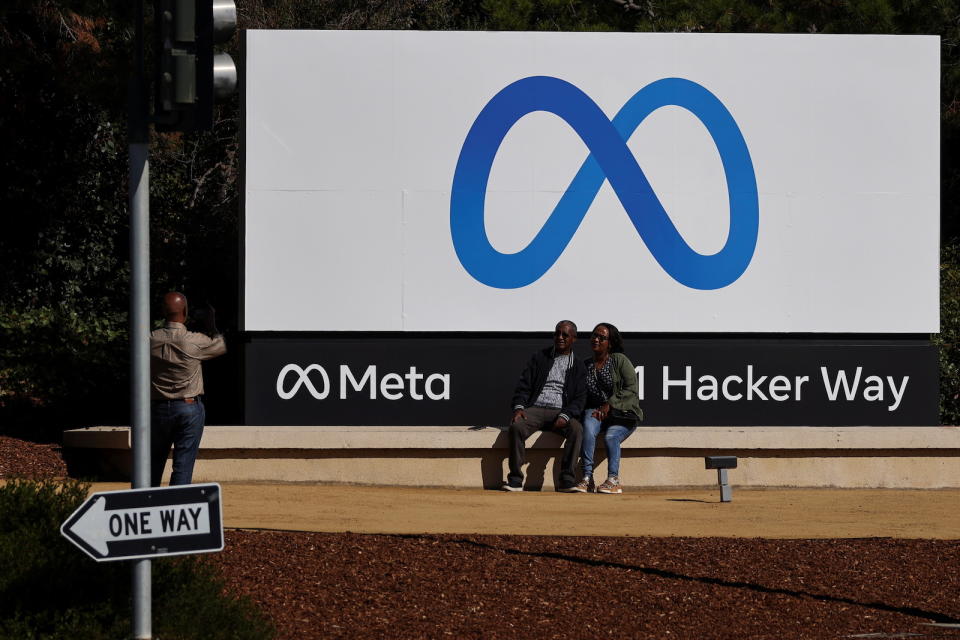 People pose in front of a sign of Meta, the new name for the company formerly known as Facebook, at its headquarters in Menlo Park, California, U.S. October 28, 2021. REUTERS/Carlos Barria - RC27JQ9AX7WN