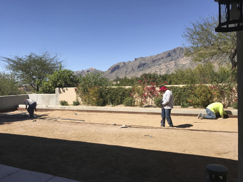 This March 2017 photo provide by John Vyborny shows workers building a Bocce ball court at Vyborny's home in Tuscon, Ariz. (John Vyborny via AP)