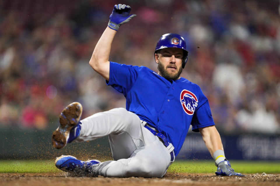 Chicago Cubs' Patrick Wisdom scores on a Eric Hosmer single against the Cincinnati Reds in the sixth inning of a baseball game in Cincinnati, Tuesday, April 4, 2023. (AP Photo/Jeff Dean)