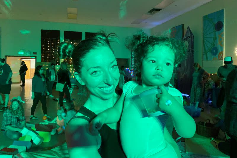 Iliana Hazzard holds her 20-month-old daughter Daphne at a "Baby Rave" in Oakland