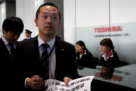 A spokesperson for Toshiba Corp speaks to the media to delay the company's earnings announcement at the company's headquarters in Tokyo, Japan, February 14, 2017. REUTERS/Toru Hanai