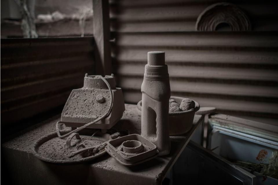 Ash-covered home goods, including parts of a blender, in an abandoned home in San Miguel Los Lotes on June 5.