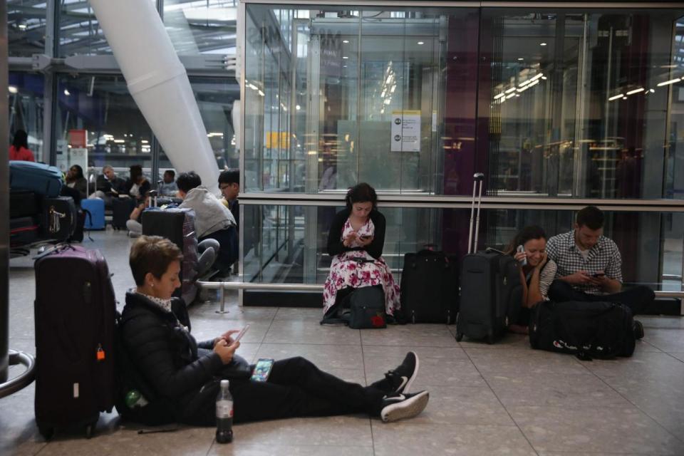 Stranded travellers wait at Heathrow Airport (AFP/Getty Images)