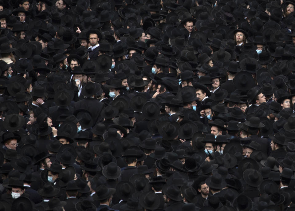 Thousands of ultra-Orthodox Jews participate in tfuneral for prominent rabbi Meshulam Soloveitchik, in Jerusalem, Sunday, Jan. 31, 2021. The mass ceremony took place despite the country's health regulations banning large public gatherings, during a nationwide lockdown to curb the spread of the virus. (AP Photo/Ariel Schalit)