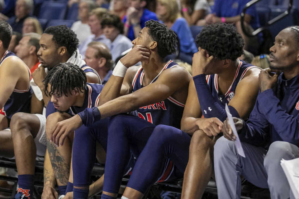 The Auburn bench reacts to their impending loss during the second half of an NCAA college basketball game against the Florida, Saturday, Feb. 10, 2024, in Gainesville, Fla. (AP Photo/Alan Youngblood)