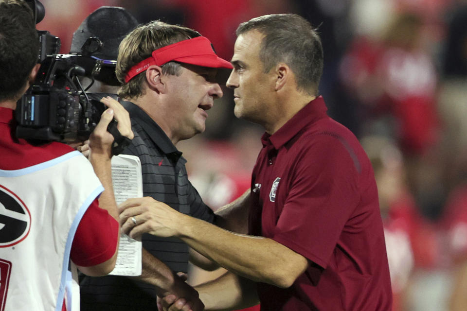 Georgia coach Kirby Smart shakes hands with South Carolina coach Shane Beamer, right, after an NCAA college football game Saturday, Sept. 18, 2021, in Athens, Ga. Georgia won 40-13. (AP Photo/Butch Dill)